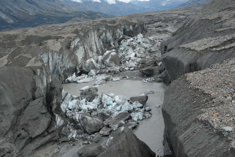 The ice-walled canyon at the terminus of the Kaskawulsh Glacier, with recently collapsed ice blocks. This canyon now carries almost all meltwater from the toe of the glacier down the Kaskawulsh Valley and toward the Gulf of Alaska. (Credit: Jim Best/University of Illinois)